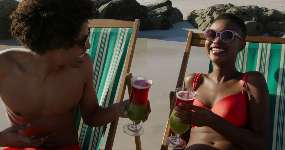 Couple Relaxing on Beach Loungers, Enjoying Tropical Drinks - Free Images, Stock Photos and Pictures on Pikwizard.com