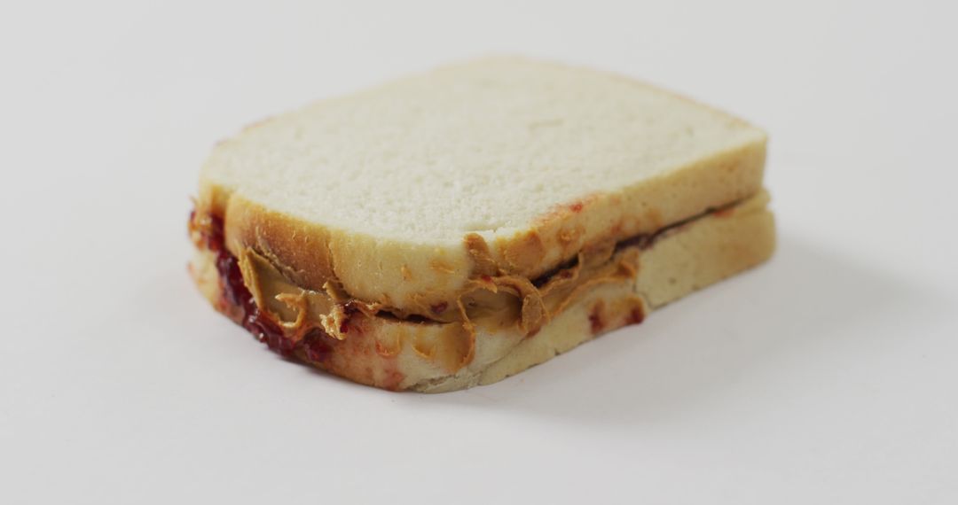 Close-Up of a Peanut Butter and Jelly Sandwich on White Background - Free Images, Stock Photos and Pictures on Pikwizard.com