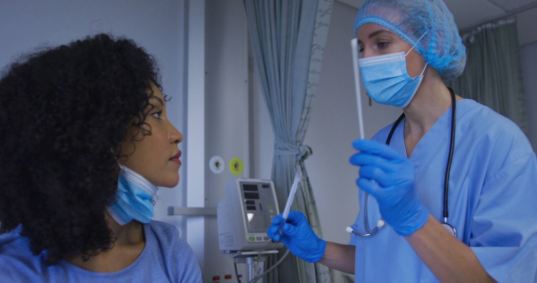 Caucasian female doctor wearing face mask giving covid swab test to female patient - Free Images, Stock Photos and Pictures on Pikwizard.com