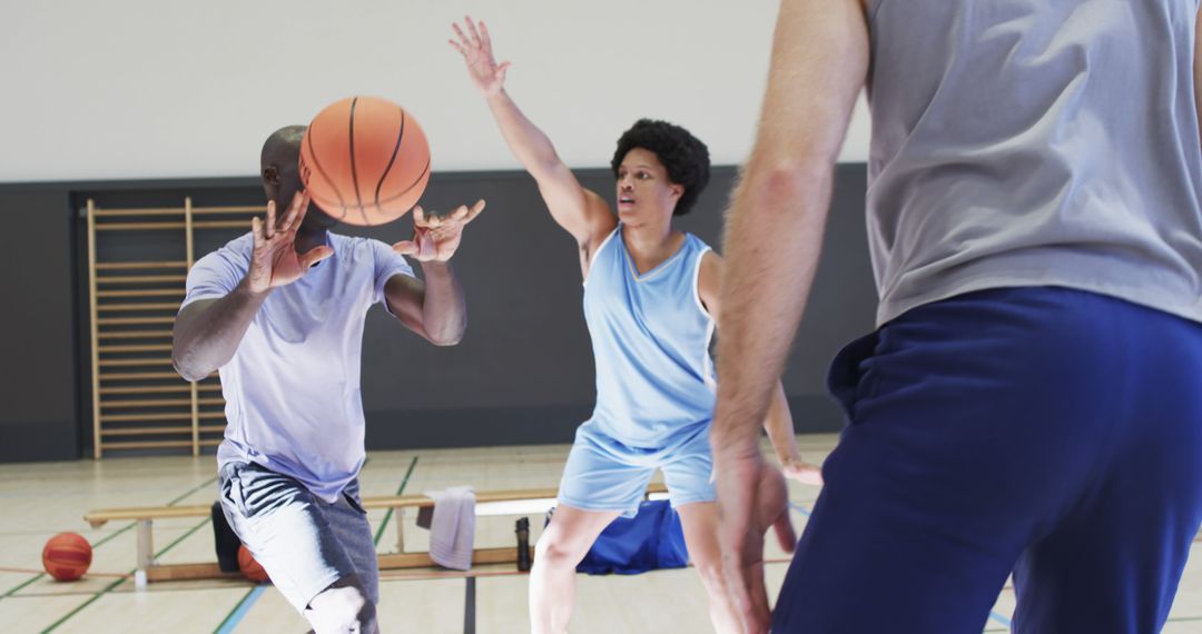 Diverse Team Engaging in Intense Basketball Training Session Indoors