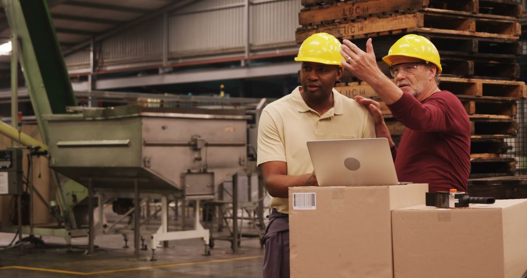 Engineers Collaborating in Manufacturing Warehouse with Laptop - Free Images, Stock Photos and Pictures on Pikwizard.com