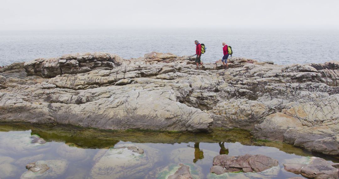 Senior Hikers Exploring Rocky Coastal Terrain