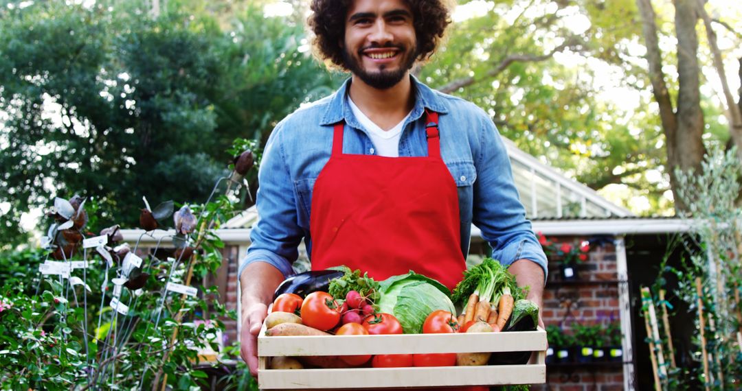 Happy Farmer Holding Fresh Vegetables Harvest in Wooden Crate - Free Images, Stock Photos and Pictures on Pikwizard.com