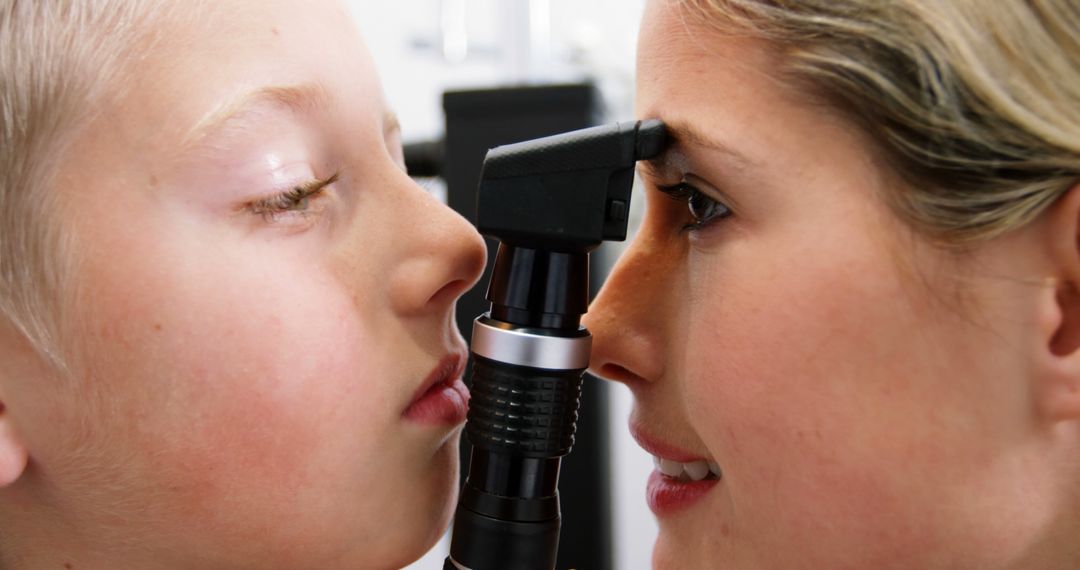 Optometrist Examining Child's Eye with Ophthalmoscope - Free Images, Stock Photos and Pictures on Pikwizard.com