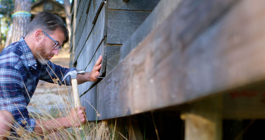 Man Examining Wooden Structure in Outdoor Environment - Free Images, Stock Photos and Pictures on Pikwizard.com