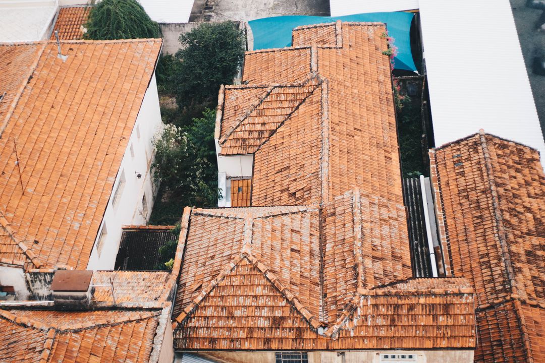 Aerial pattern of weathered terracotta rooftops in tight urban neighborhood