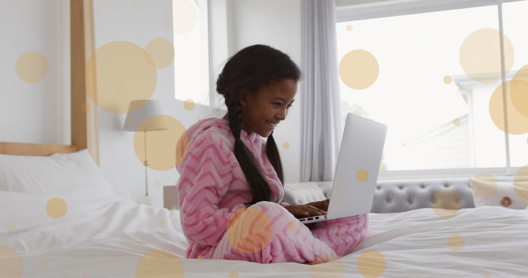 Smiling Girl with Laptop on Cozy Bed with Light Overlays