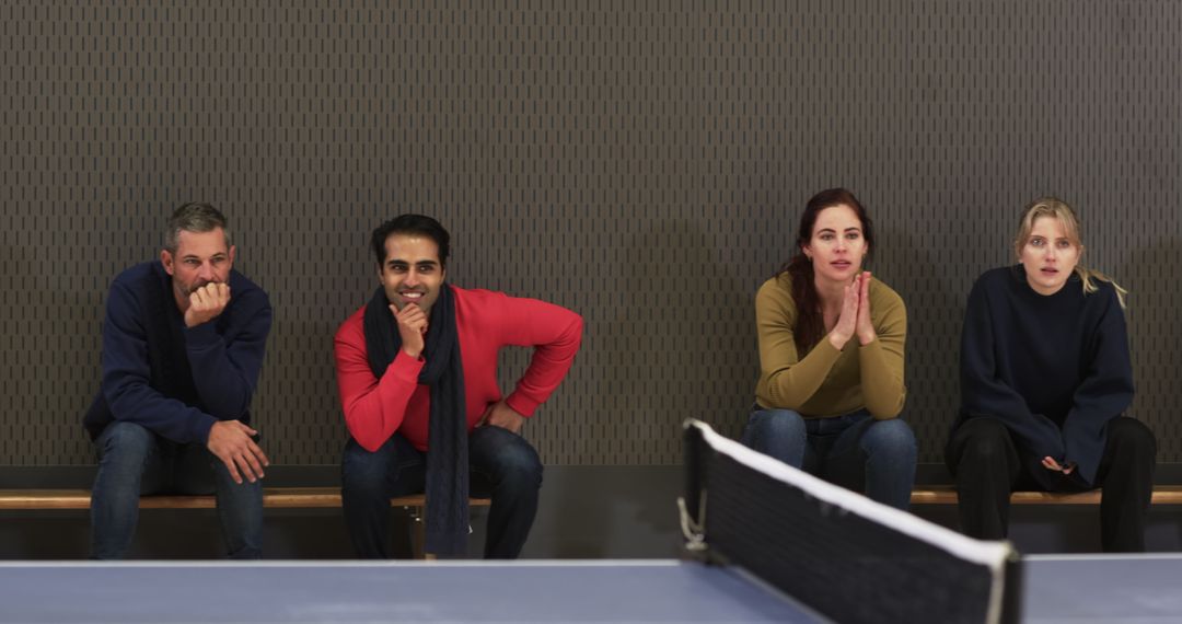 Diverse Friends Watching Intense Table Tennis Match with Enthusiasm