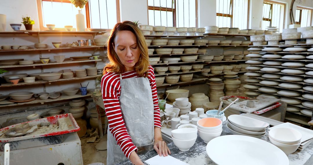 Female Potter Working in Studio with Ceramic Creations - Free Images, Stock Photos and Pictures on Pikwizard.com