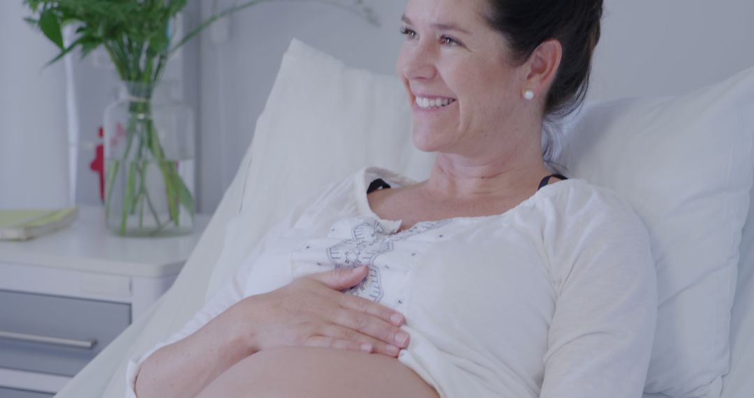 Smiling Pregnant Woman in Hospital Bed Awaiting Birth - Free Images, Stock Photos and Pictures on Pikwizard.com