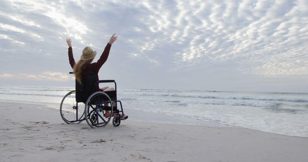 Wheelchair User Celebrating Freedom on Beach at Sunset - Free Images, Stock Photos and Pictures on Pikwizard.com