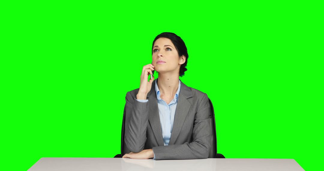 Businesswoman Thinking at Desk in Front of Green Screen - Free Images, Stock Photos and Pictures on Pikwizard.com