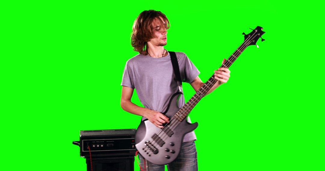 Young Musician Playing Electric Bass Guitar on Green Screen Background - Free Images, Stock Photos and Pictures on Pikwizard.com