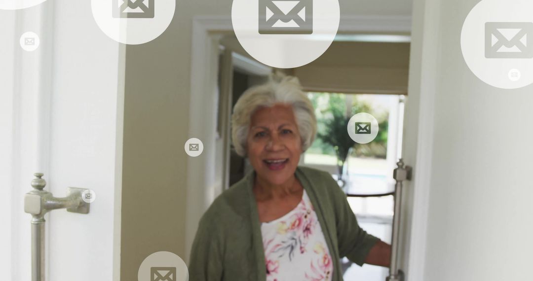 Senior woman opening door with email icons overlay