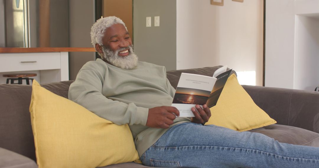 Senior Man Reading Magazine on Modern Couch at Home