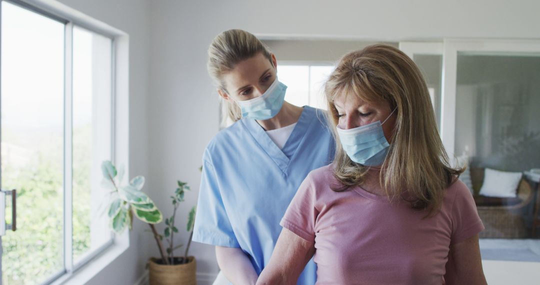 Healthcare Worker Assisting Senior Woman Wearing Face Masks - Free Images, Stock Photos and Pictures on Pikwizard.com