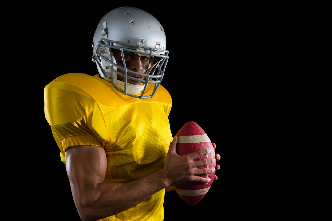 American football player holding a ball with both his hands - Free Images, Stock Photos and Pictures on Pikwizard.com