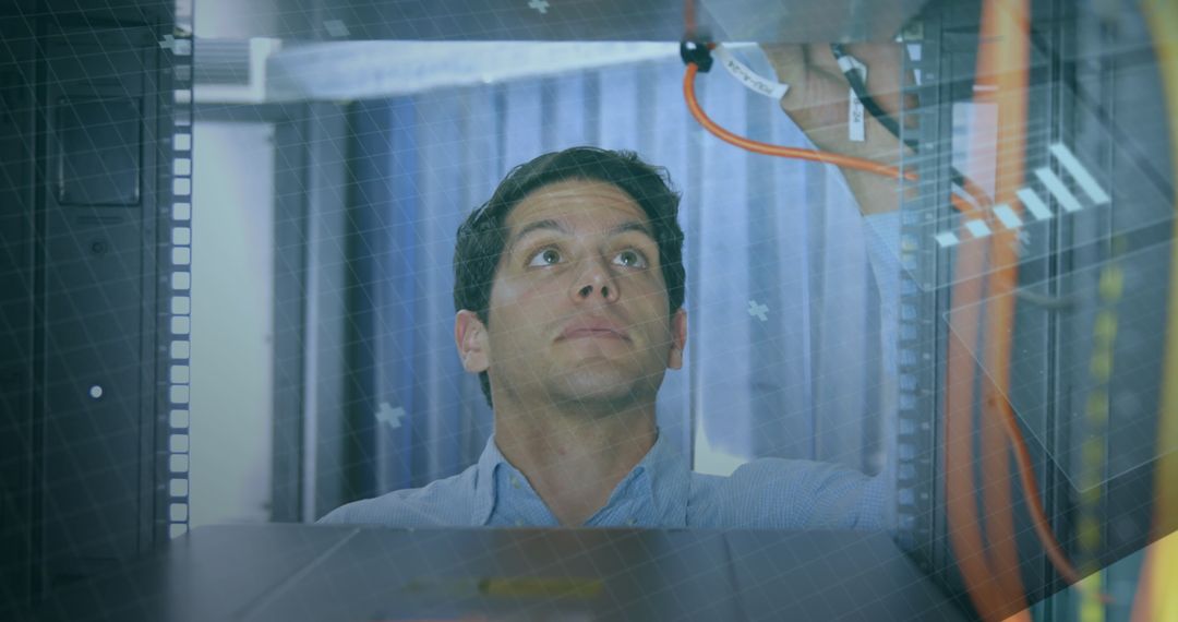 Technician Inspecting Network Server Cables in Data Center