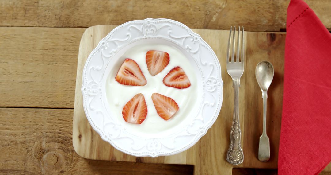 Slices of strawberries in plate with spoon on chopping board - Free Images, Stock Photos and Pictures on Pikwizard.com