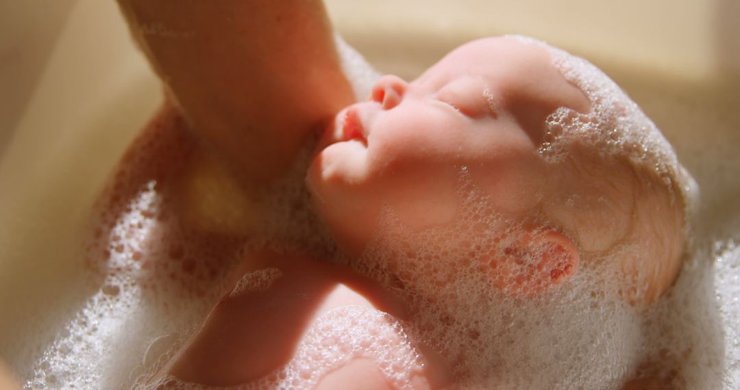 A Caucasian baby enjoys a bubble bath, with copy space - Free Images, Stock Photos and Pictures on Pikwizard.com