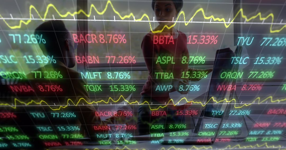 Colleagues Analyzing Digital Display of Dynamic Stock Market Tickers