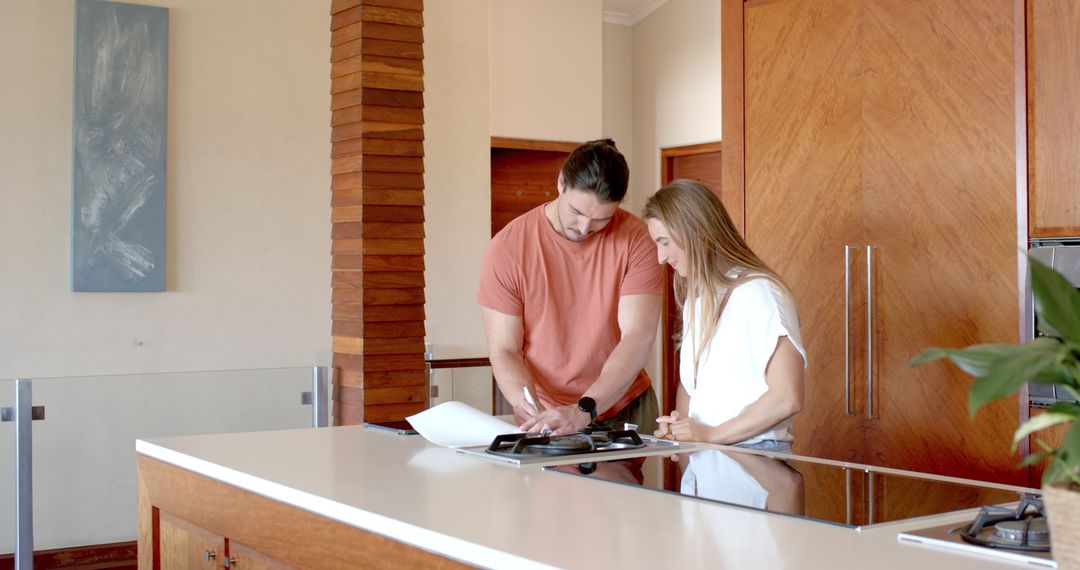 Couple Collaborating on Home Plans in Modern Kitchen
