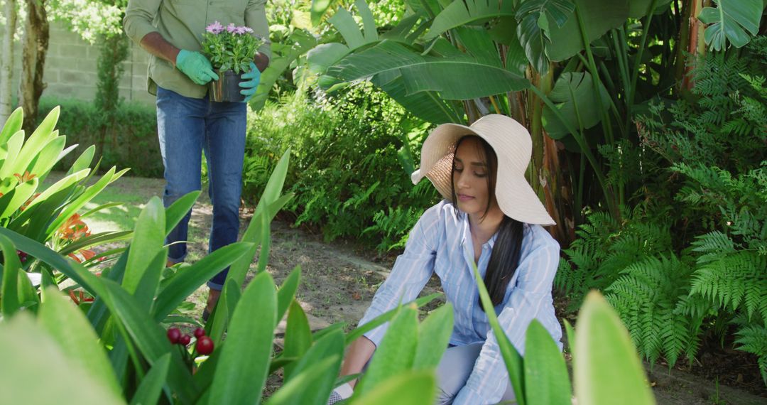 Couple Gardening in Lush Backyard with Tropical Plants - Free Images, Stock Photos and Pictures on Pikwizard.com