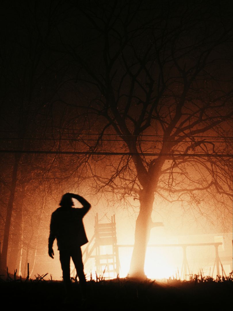Silhouette of a Person near Bright Light in Foggy Night - Free Images, Stock Photos and Pictures on Pikwizard.com