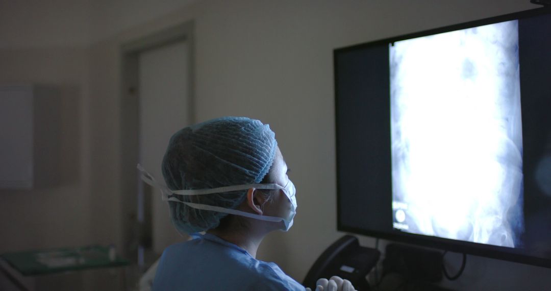 Healthcare Worker Analyzing X-Ray Image in Hospital - Free Images, Stock Photos and Pictures on Pikwizard.com