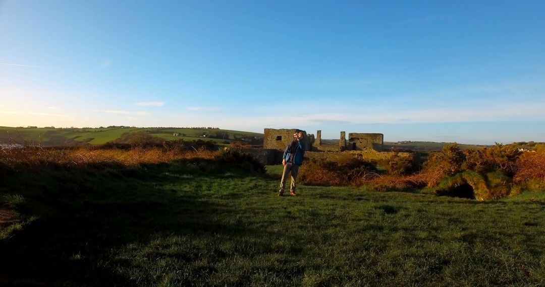 Hiker Exploring Ruins in Countryside at Dawn - Free Images, Stock Photos and Pictures on Pikwizard.com