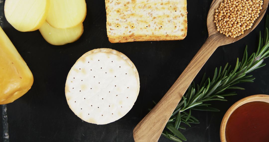 Cheese Board with Crackers, Mustard Seeds, and Fresh Rosemary - Free Images, Stock Photos and Pictures on Pikwizard.com