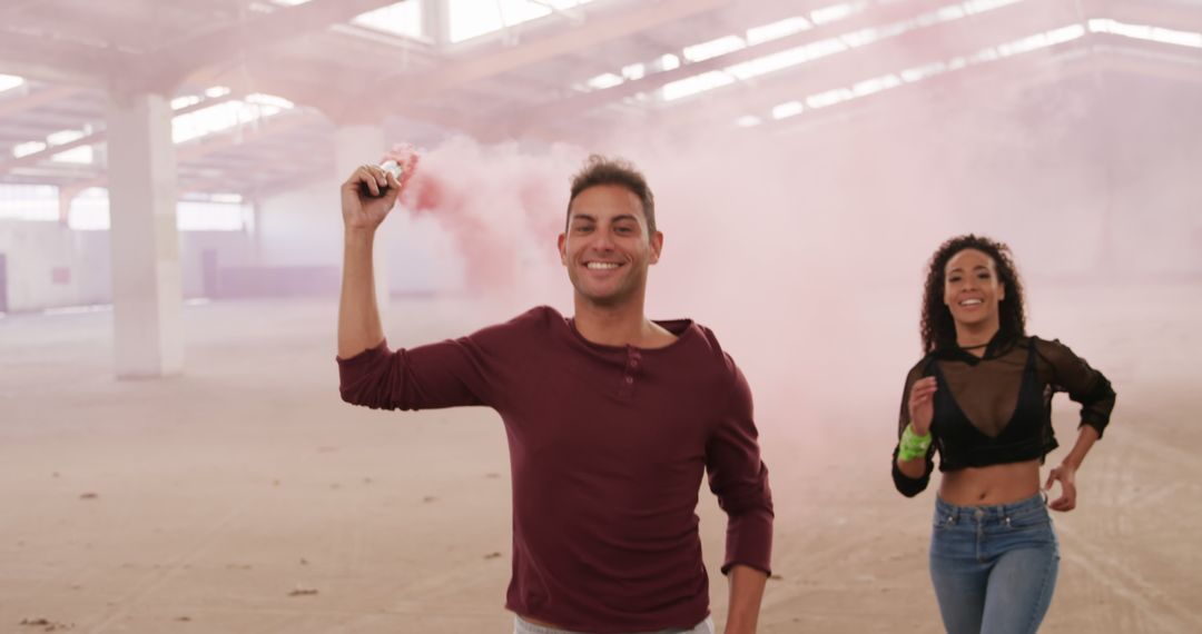 Smiling Man and Happy Woman Playing with Smoke Bomb indoors - Free Images, Stock Photos and Pictures on Pikwizard.com