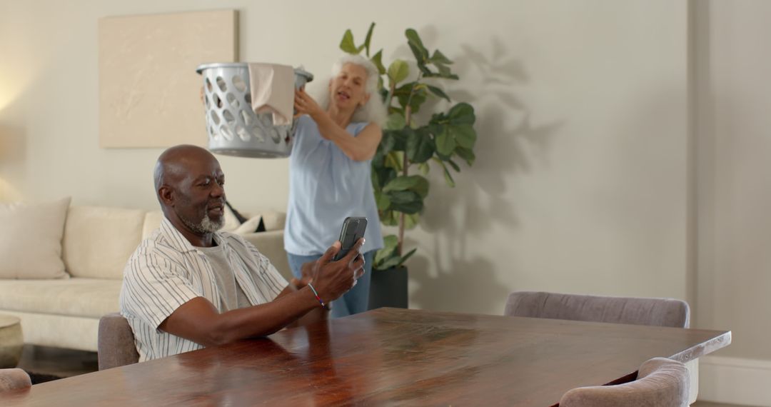 Senior Couple Relaxing at Home Navigating Smartphone