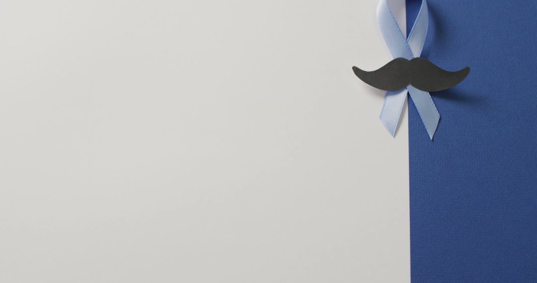 Image of paper moustache and pale blue prostate cancer ribbon on white and blue background - Free Images, Stock Photos and Pictures on Pikwizard.com