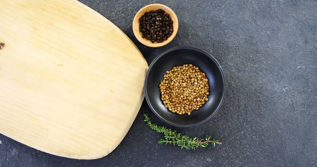 Coriander and Black Pepper on Slate Surface with Cutting Board - Free Images, Stock Photos and Pictures on Pikwizard.com