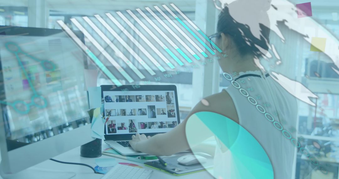 Businesswoman Analyzing Data on Laptop with Digital Graphics