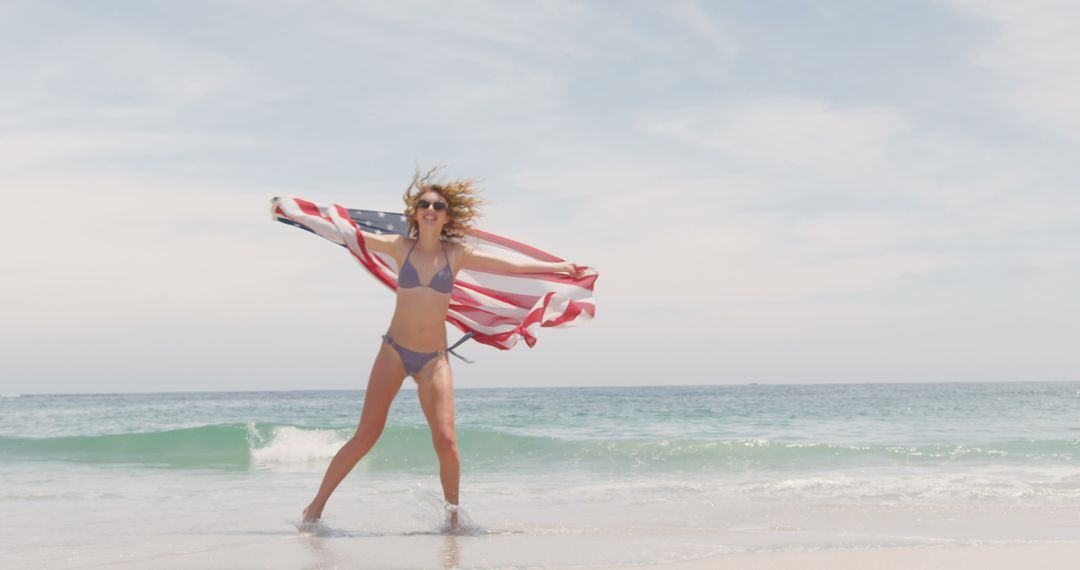 Joyful Woman Running on Beach with American Flag