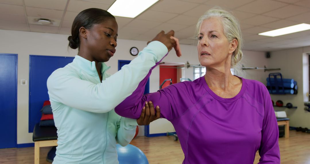 Physical Therapist Assisting Woman in Rehabilitation Session - Free Images, Stock Photos and Pictures on Pikwizard.com