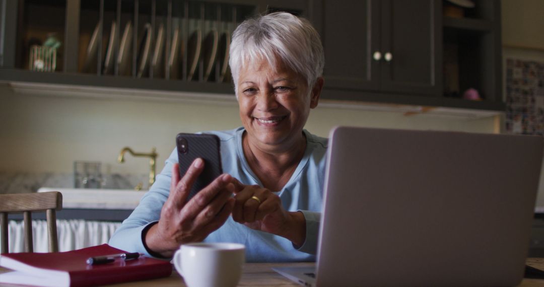 Senior Woman Smiling Using Smartphone at Home Office - Free Images, Stock Photos and Pictures on Pikwizard.com