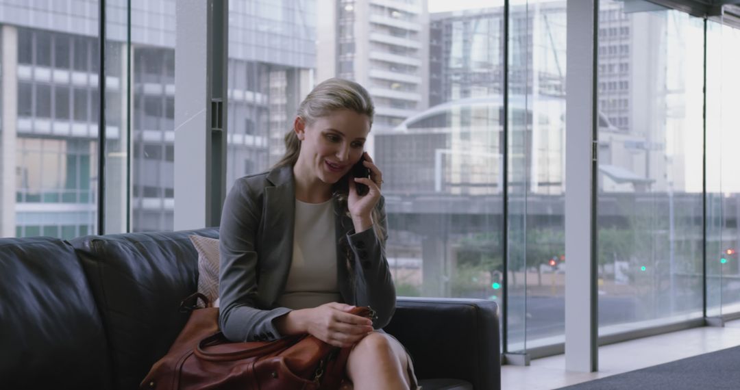 Businesswoman Talking on Phone in Modern Office Lobby - Free Images, Stock Photos and Pictures on Pikwizard.com