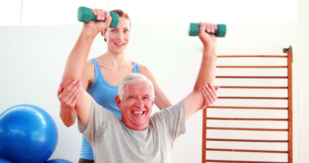 Smiling Senior Man Lifting Weights with Woman Personal Trainer in Gym - Free Images, Stock Photos and Pictures on Pikwizard.com