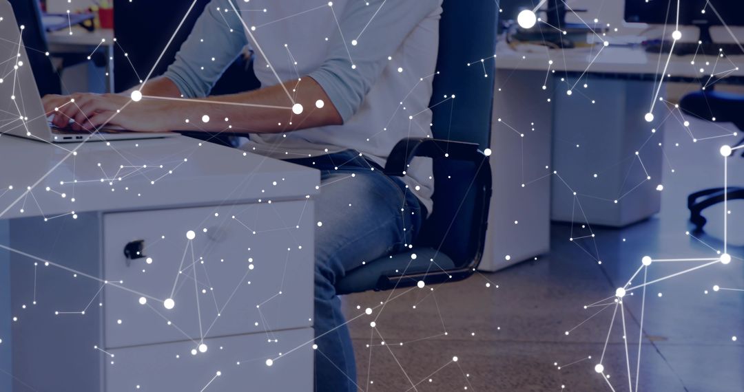 Typing on Laptop in Open-Plan Office with Digital Network Overlay and Minimalist Workspace
