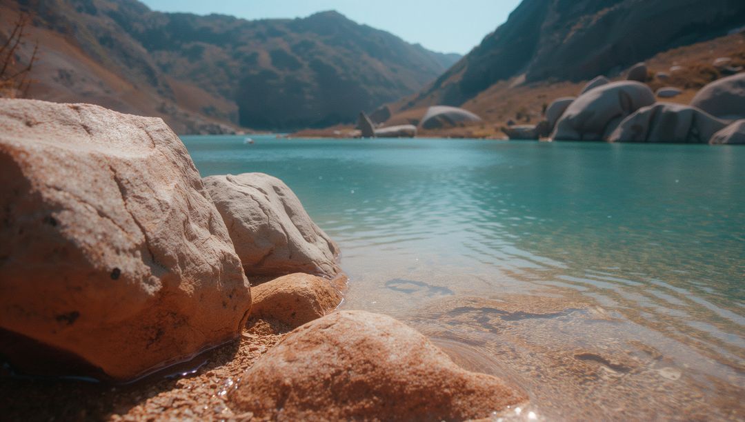 Serene Mountain Lake with Turquoise Waters and Distant Peaks