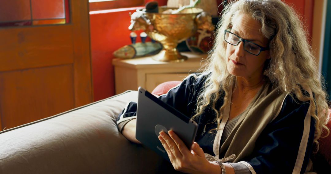 Senior Woman Wearing Glasses Using Tablet at Home - Free Images, Stock Photos and Pictures on Pikwizard.com