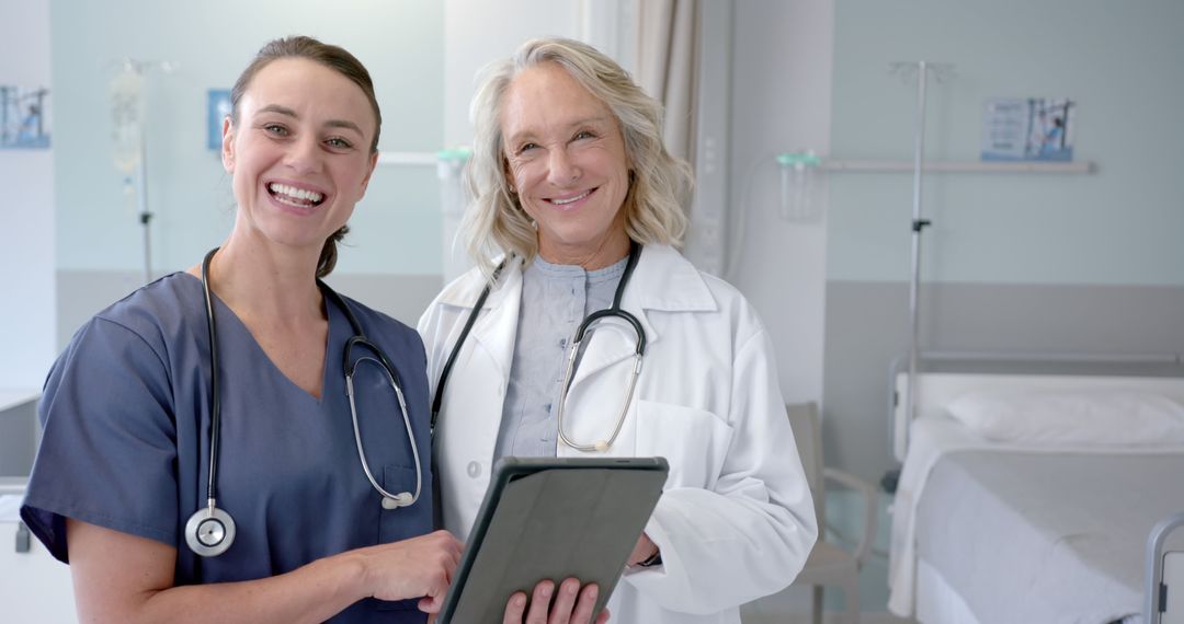 Two Happy Nurses Discussing Patient Care in Modern Hospital Ward - Free Images, Stock Photos and Pictures on Pikwizard.com