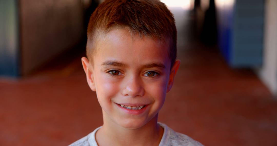 Smiling Boy with Short Brown Hair in Outdoor Passage - Free Images, Stock Photos and Pictures on Pikwizard.com