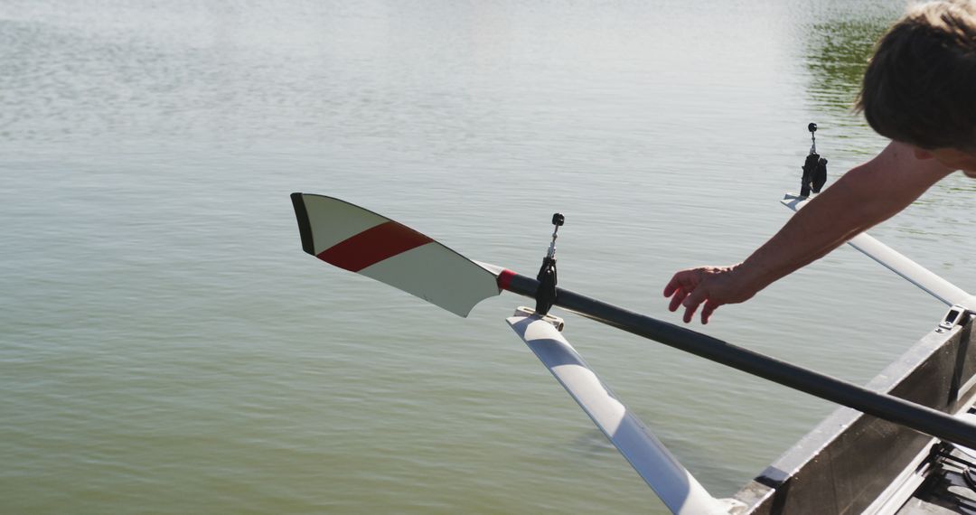 Person Adjusting Oar on Boat in Calm Water - Free Images, Stock Photos and Pictures on Pikwizard.com