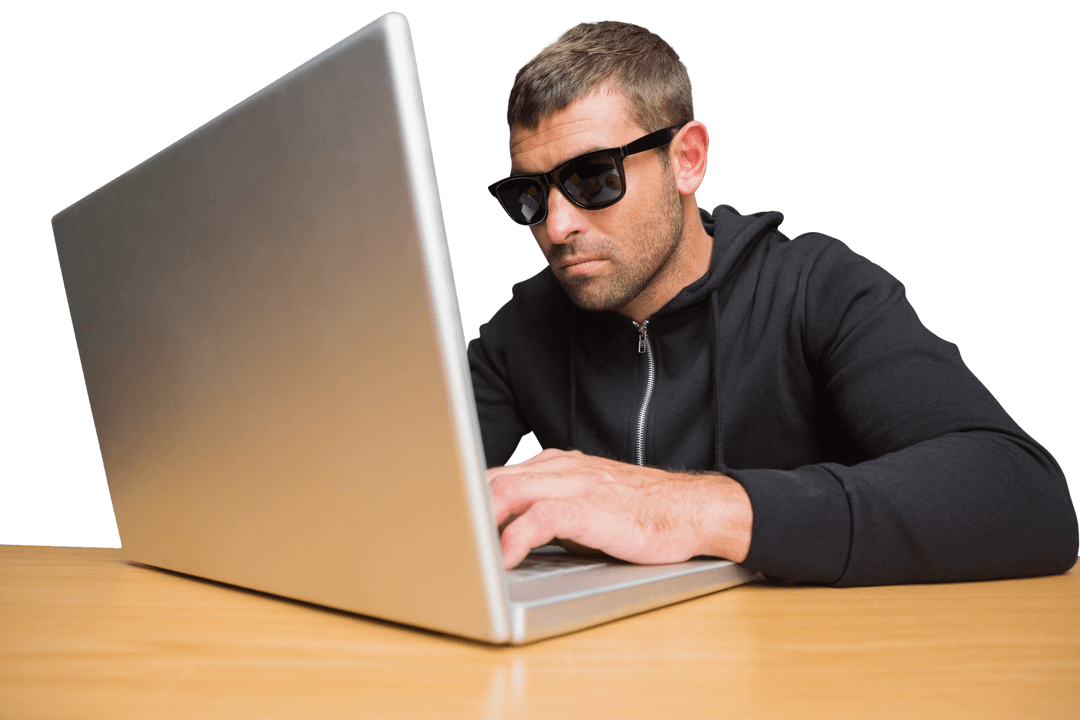 Cybercriminal Wearing Sunglasses Typing on Silver Laptop Transparent Background