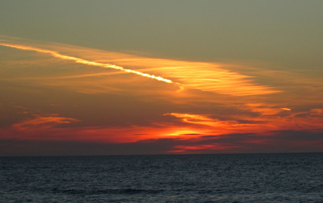 Colorful Sunset Over Calm Ocean with Scenic Clouds - Free Images, Stock Photos and Pictures on Pikwizard.com
