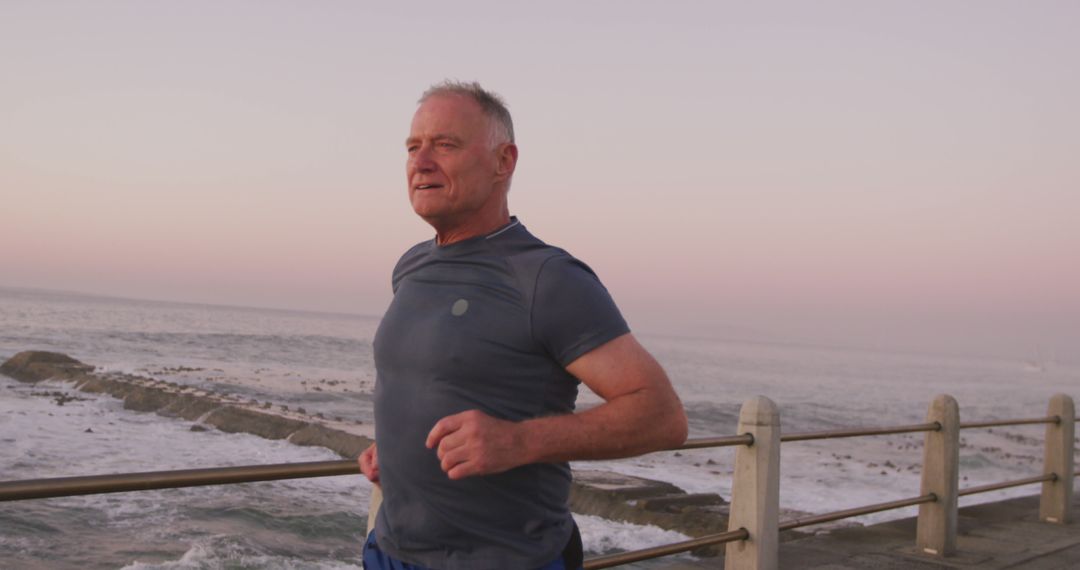 Active Senior Man Running by Seaside Promenade at Sunset - Free Images, Stock Photos and Pictures on Pikwizard.com